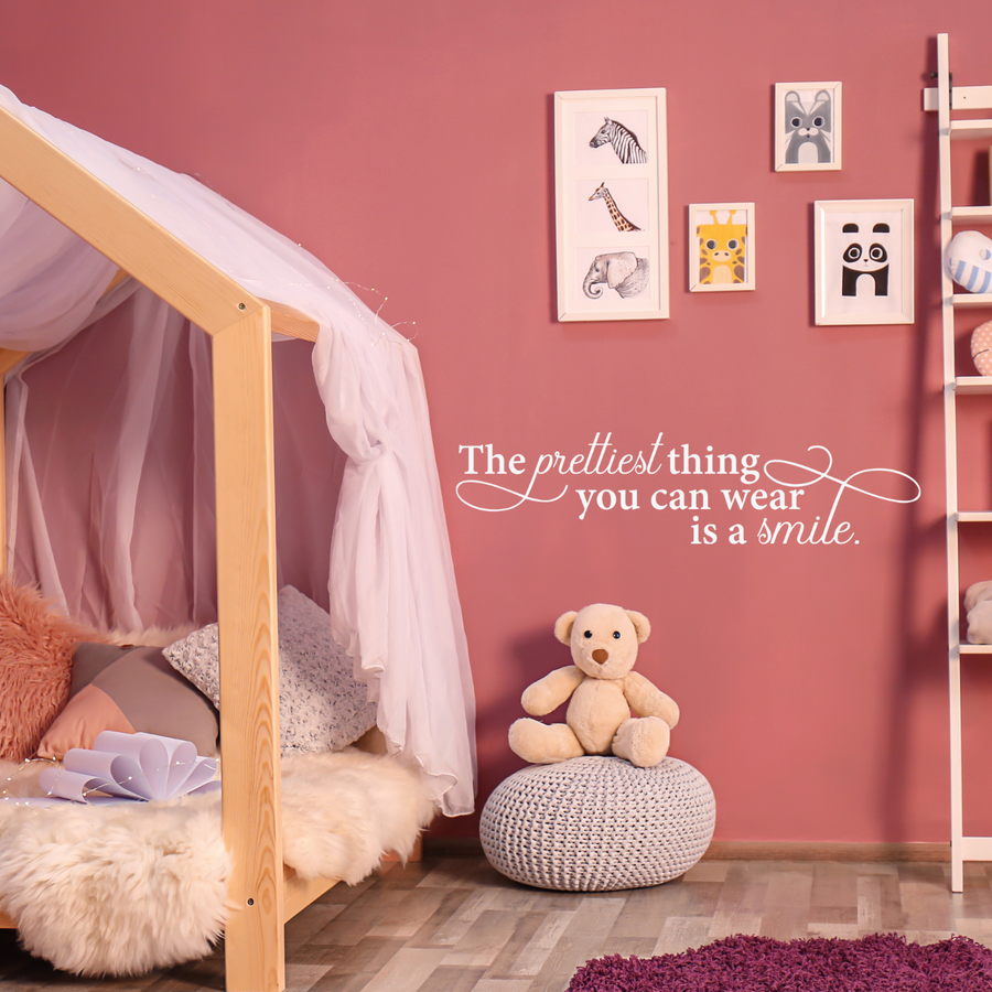 Motivational wall decal featuring inspirational wall quotes and stickers for the-prettiest-thing-you-can-wear-is-a-smile. 