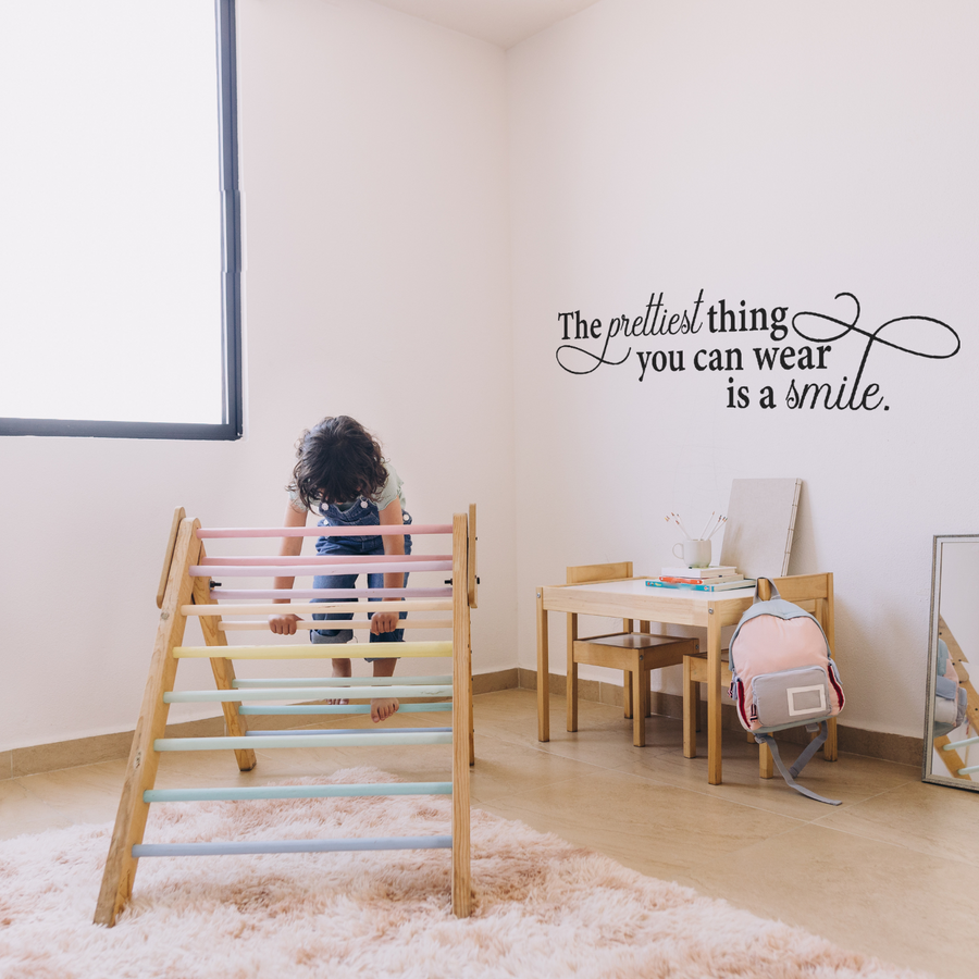 Motivational wall decal featuring inspirational wall quotes and stickers for the-prettiest-thing-you-can-wear-is-a-smile. 